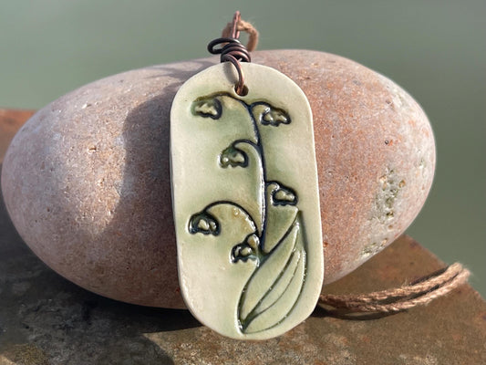 Handmade snowdrop necklace. Eco friendly jewellery. Ethical pendants made with waste clay and burnt recycled copper. Ethical jewellery.