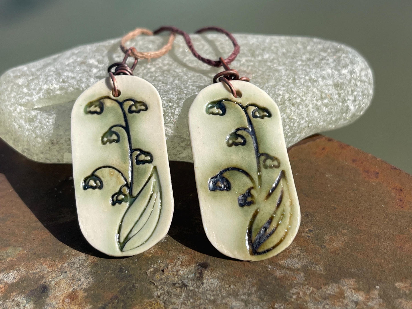 Handmade snowdrop necklace. Eco friendly jewellery. Ethical pendants made with waste clay and burnt recycled copper. Ethical jewellery.