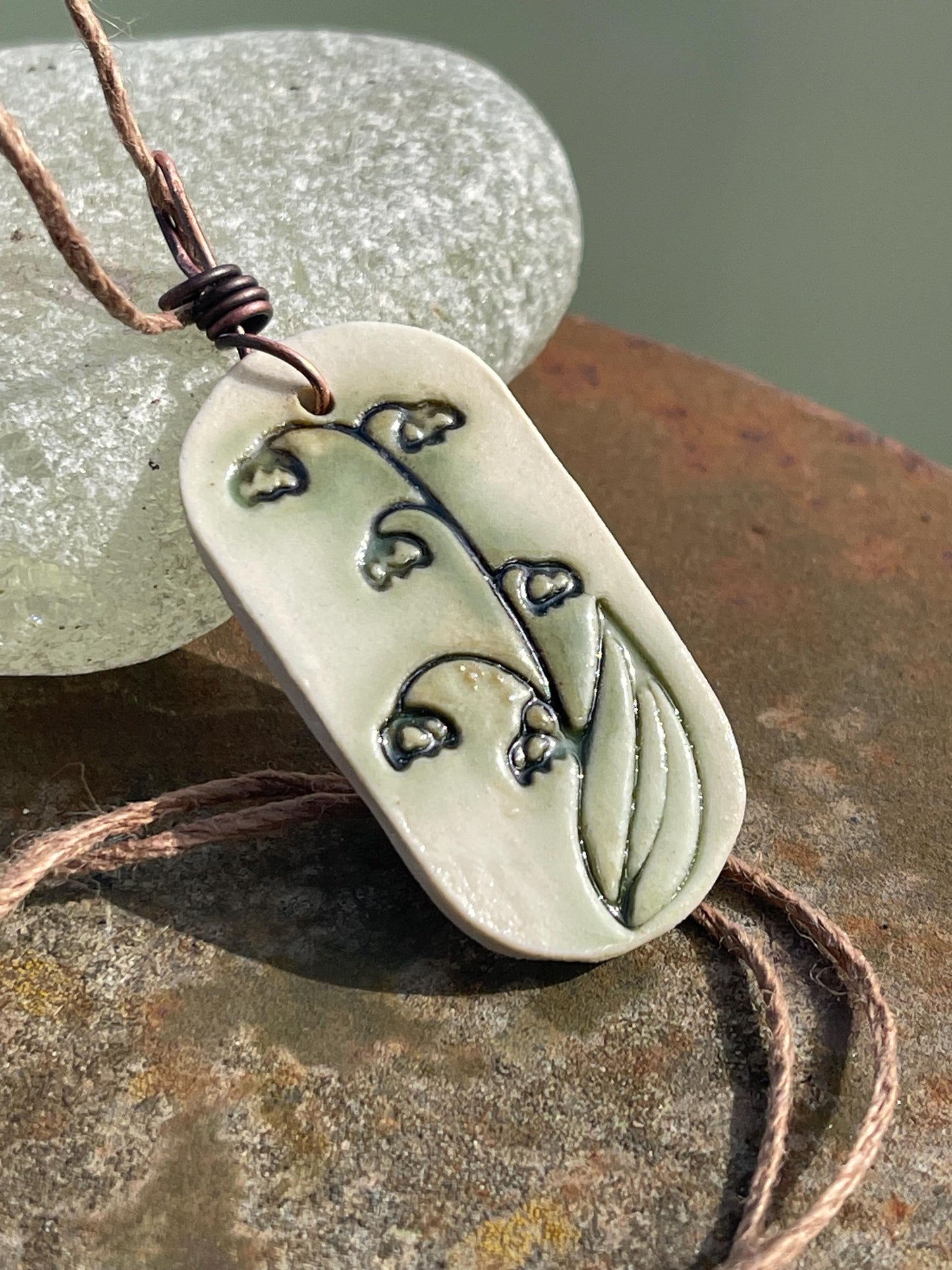 Handmade snowdrop necklace. Eco friendly jewellery. Ethical pendants made with waste clay and burnt recycled copper. Ethical jewellery.