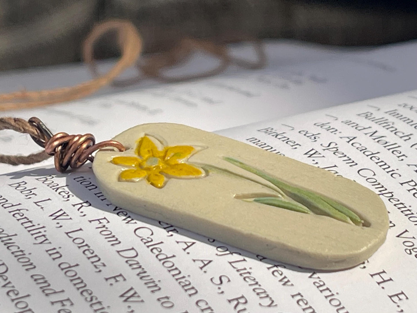 Handmade daffodil necklace. Eco friendly jewellery. Ethical pendants made with waste clay and burnt recycled copper. Ethical jewellery.