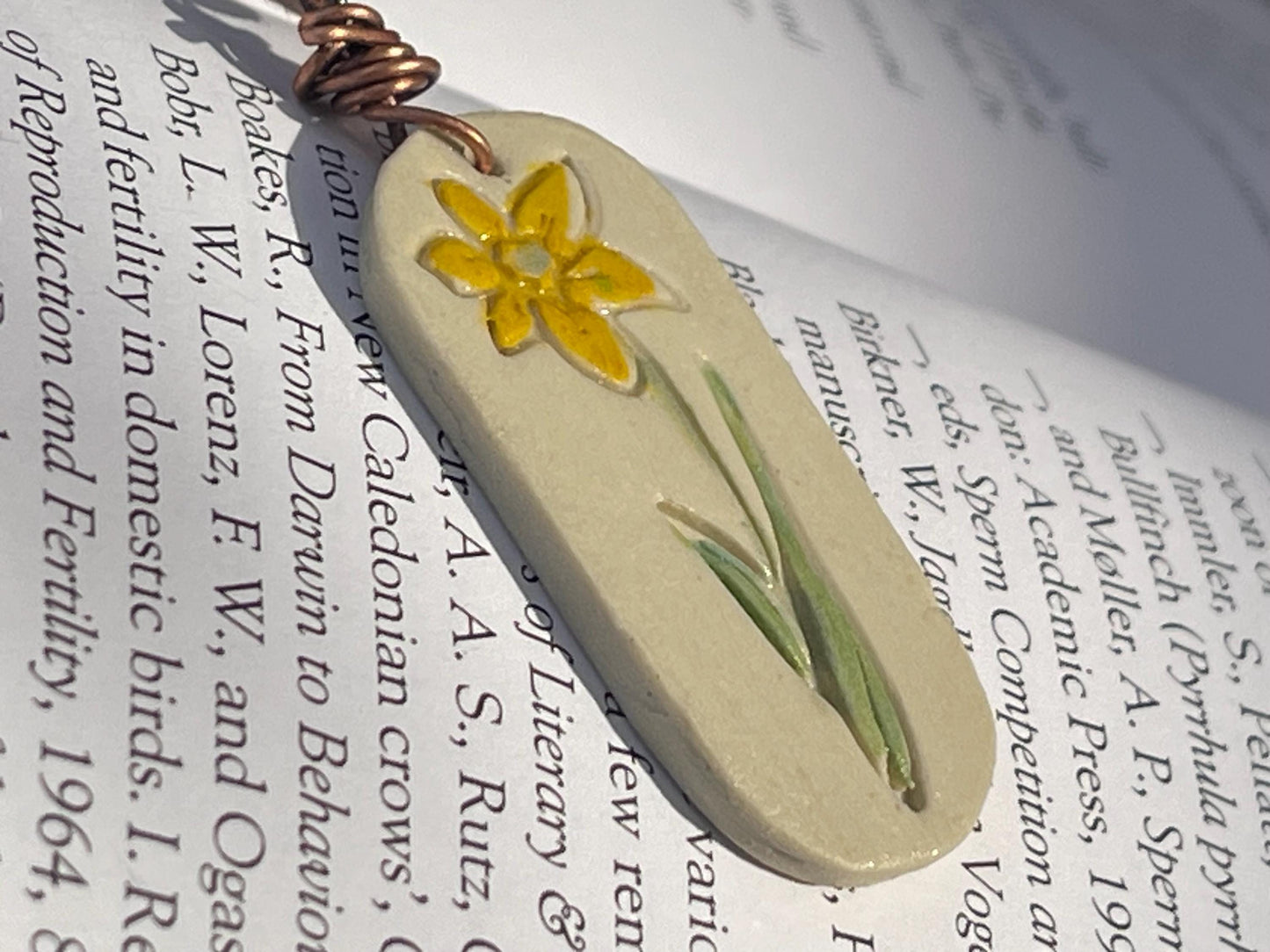 Handmade daffodil necklace. Eco friendly jewellery. Ethical pendants made with waste clay and burnt recycled copper. Ethical jewellery.