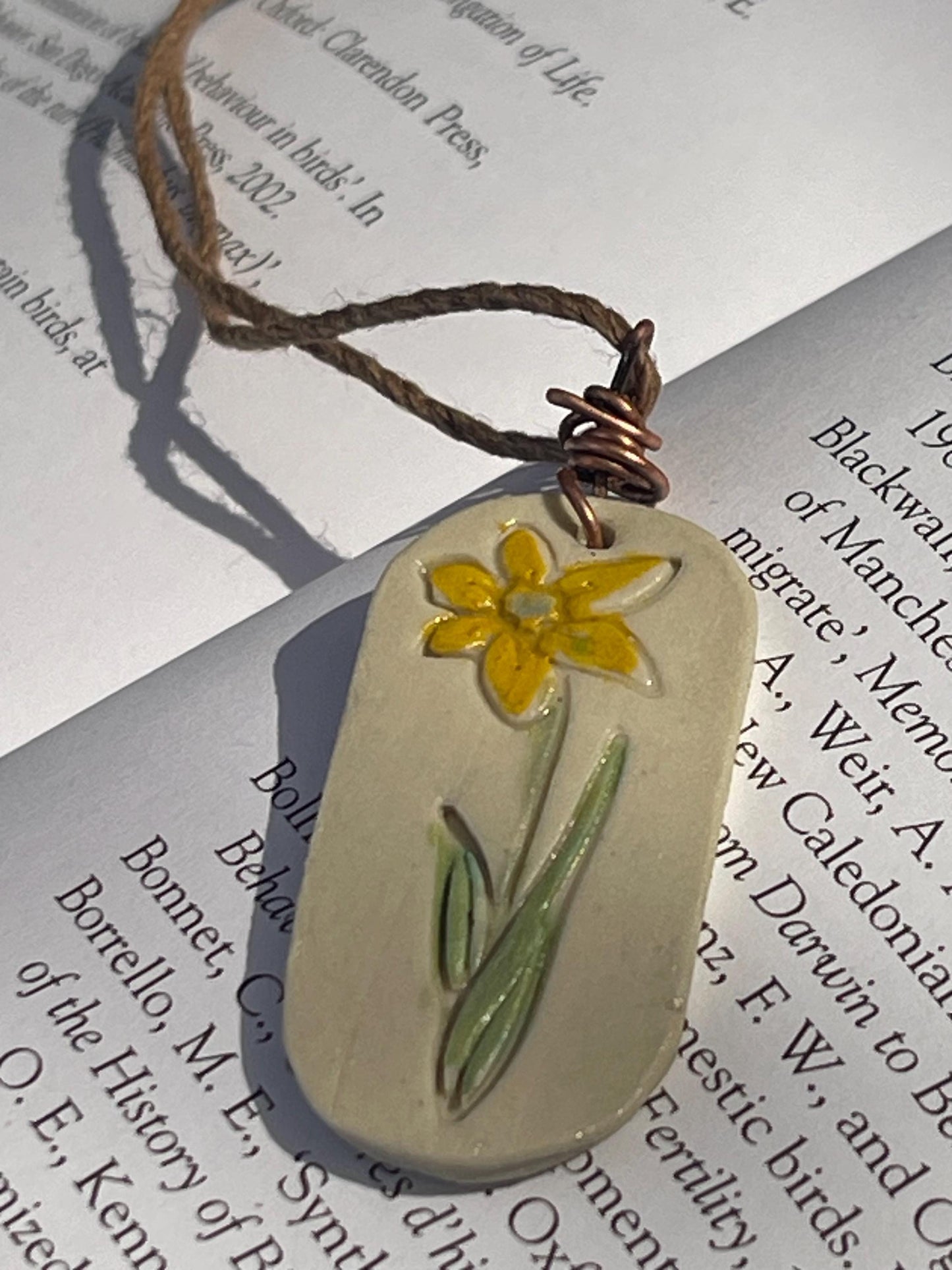 Handmade daffodil necklace. Eco friendly jewellery. Ethical pendants made with waste clay and burnt recycled copper. Ethical jewellery.