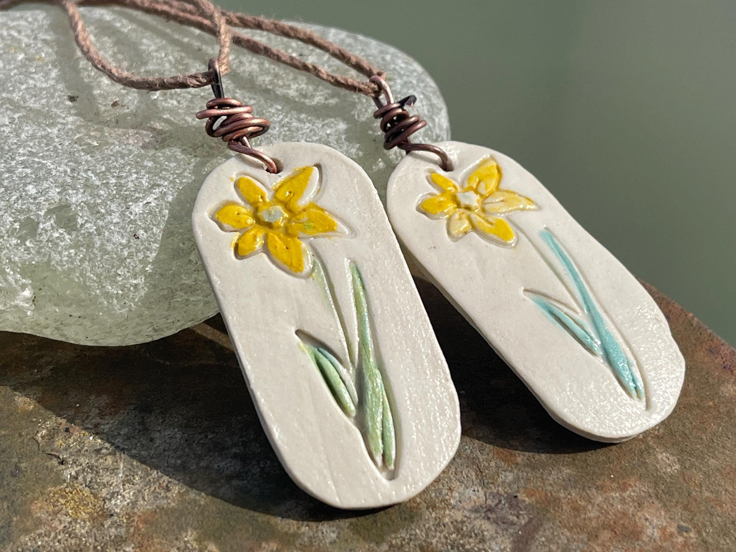 Handmade daffodil necklace. Eco friendly jewellery. Ethical pendants made with waste clay and burnt recycled copper. Ethical jewellery.