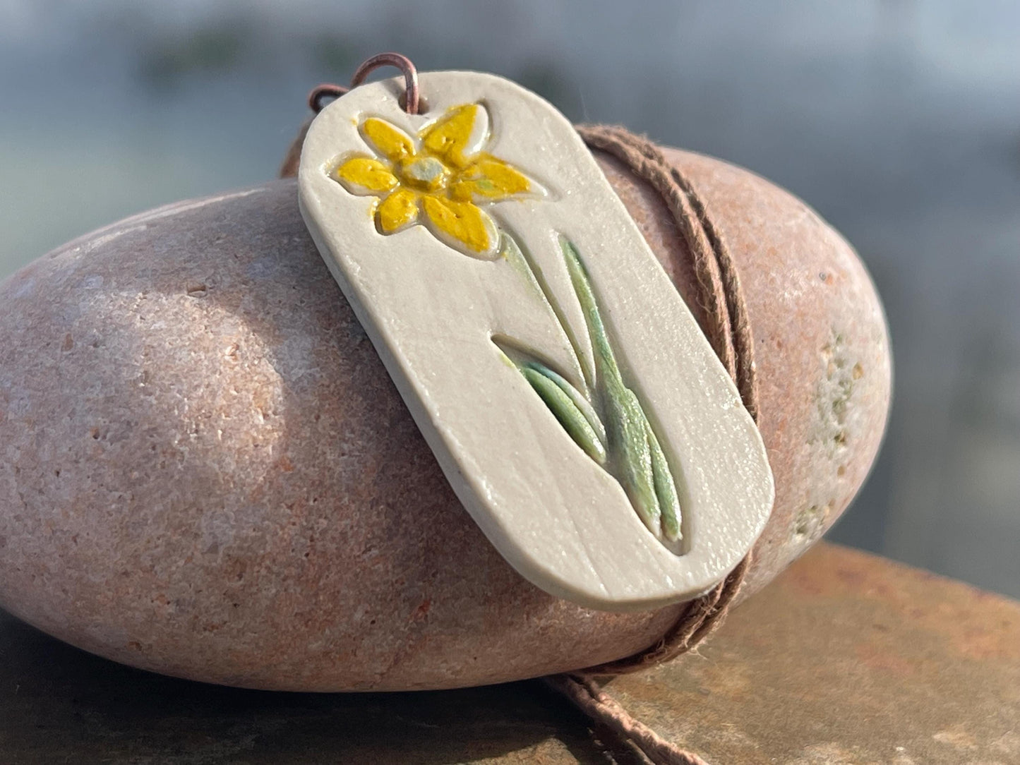 Handmade daffodil necklace. Eco friendly jewellery. Ethical pendants made with waste clay and burnt recycled copper. Ethical jewellery.