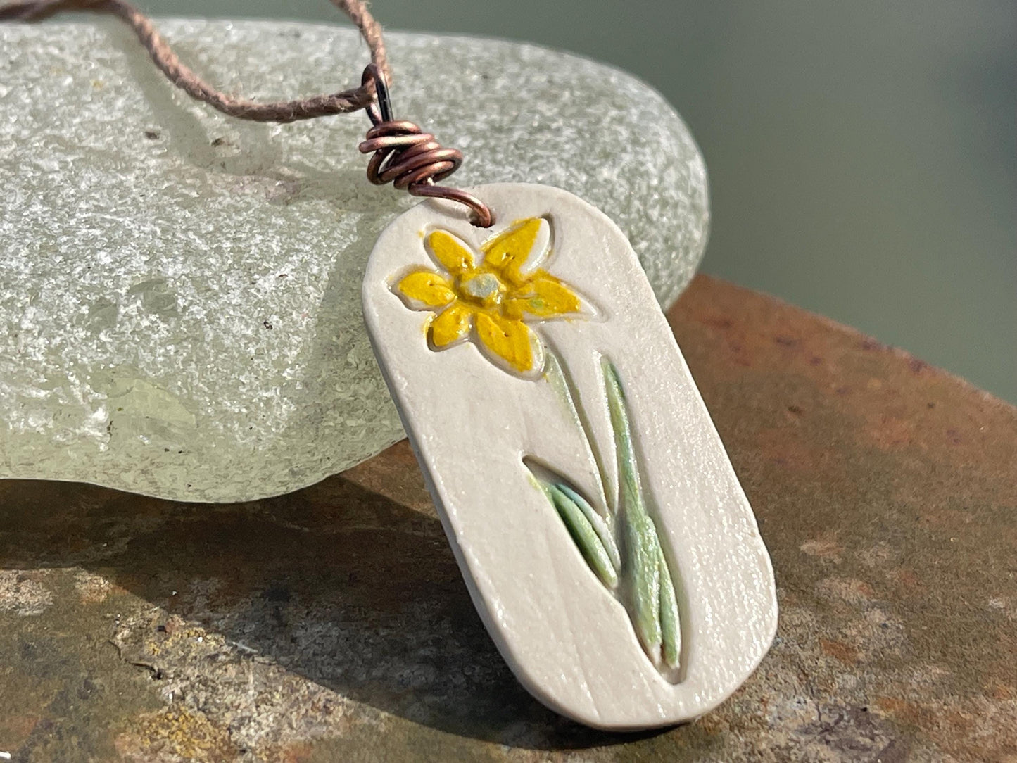 Handmade daffodil necklace. Eco friendly jewellery. Ethical pendants made with waste clay and burnt recycled copper. Ethical jewellery.