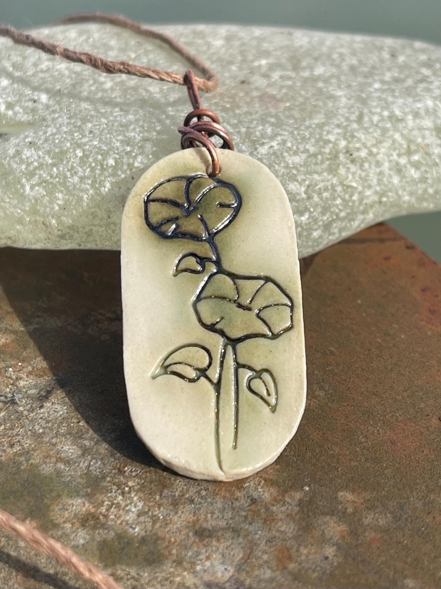 Handmade morning glory necklace. Eco friendly jewellery. Ethical pendants made with waste clay and burnt recycled copper. Ethical jewellery.