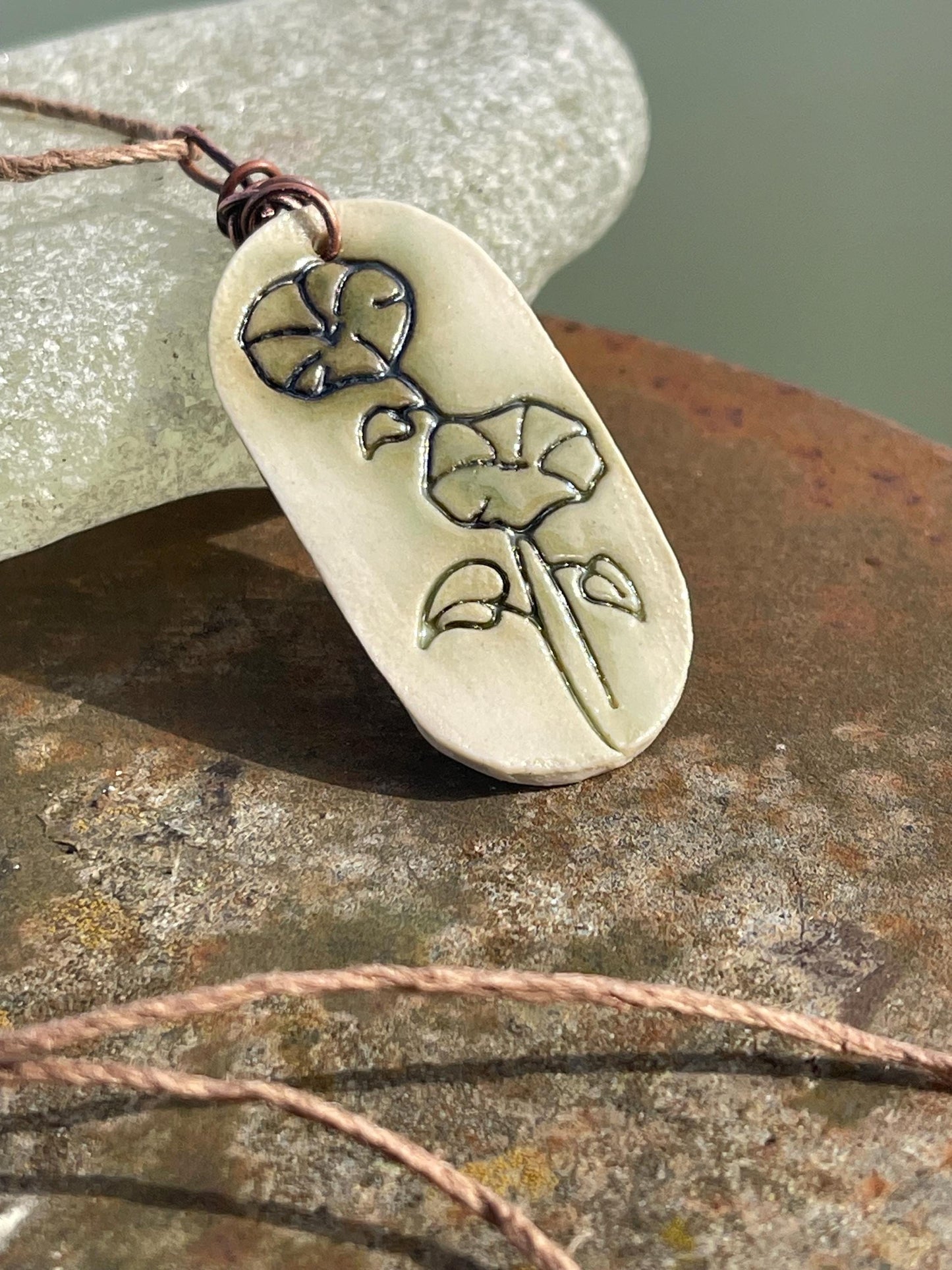 Handmade morning glory necklace. Eco friendly jewellery. Ethical pendants made with waste clay and burnt recycled copper. Ethical jewellery.