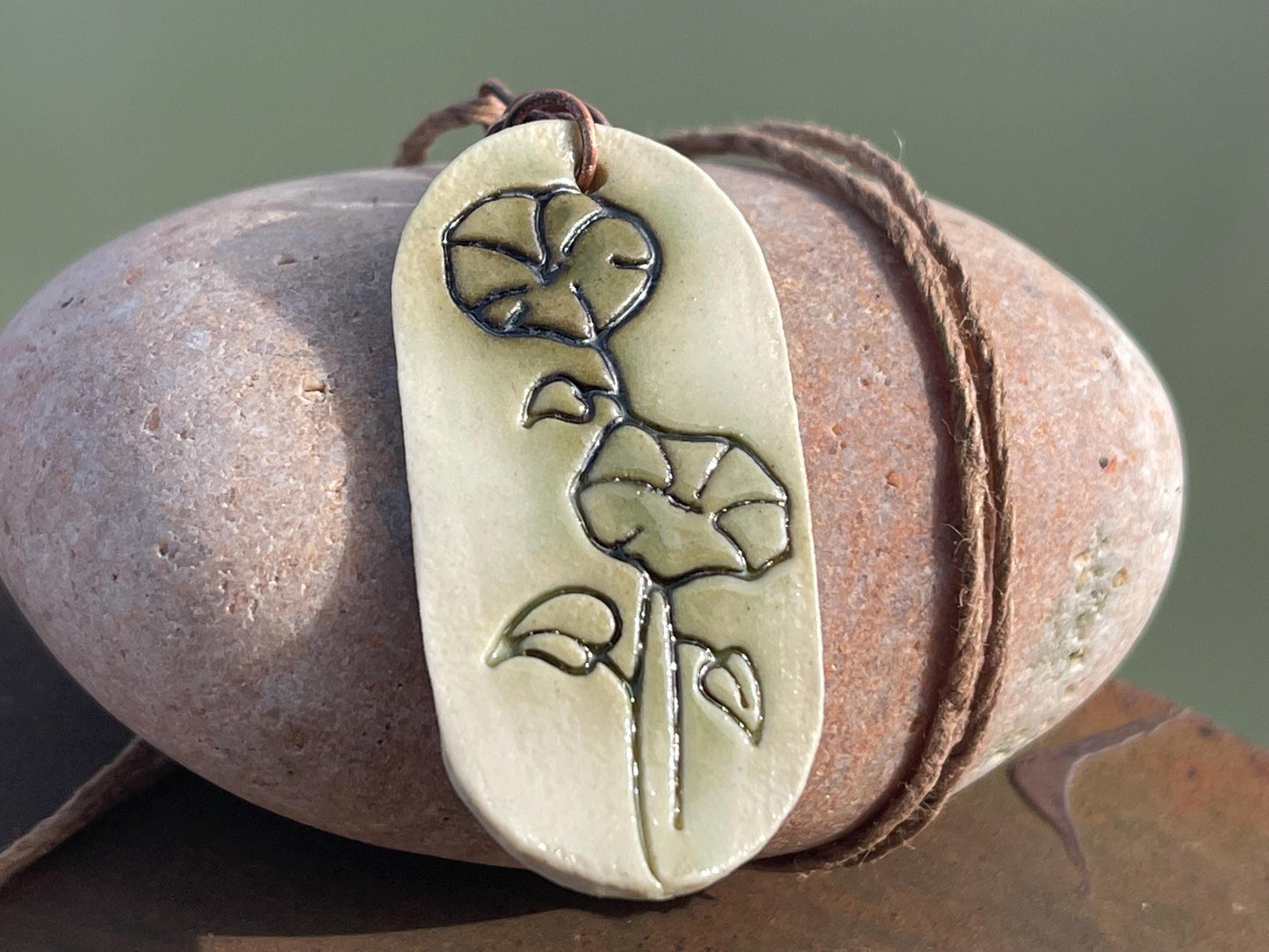 Handmade morning glory necklace. Eco friendly jewellery. Ethical pendants made with waste clay and burnt recycled copper. Ethical jewellery.