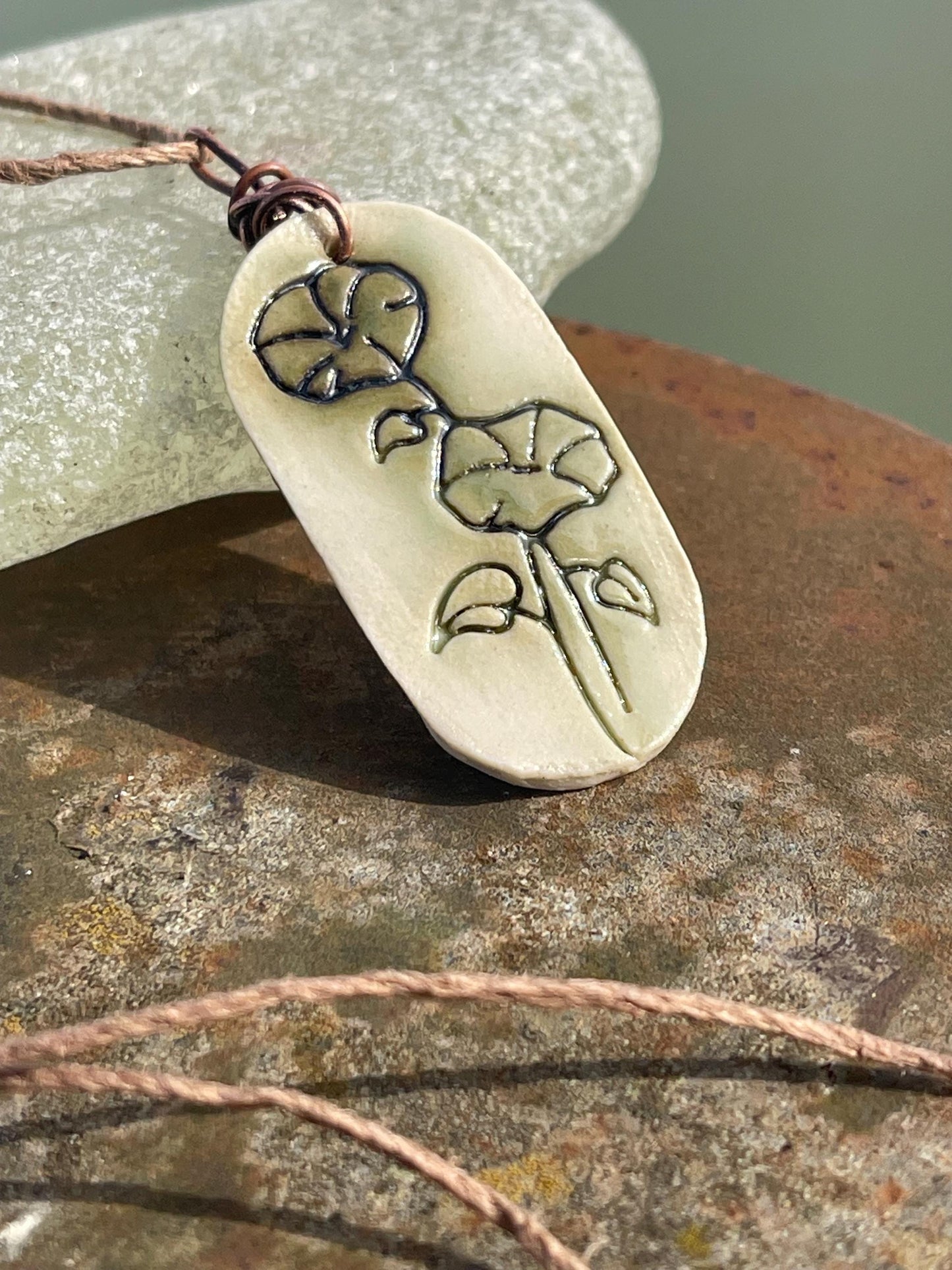 Handmade morning glory necklace. Eco friendly jewellery. Ethical pendants made with waste clay and burnt recycled copper. Ethical jewellery.