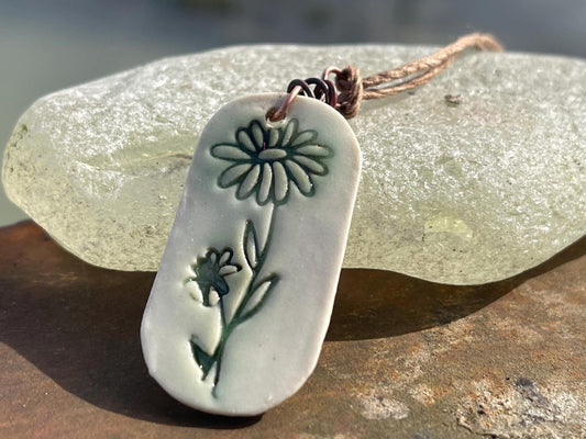 Handmade daisy necklace. Eco friendly jewellery. Ethical pendants made with waste clay and burnt recycled copper. Ethical jewellery.