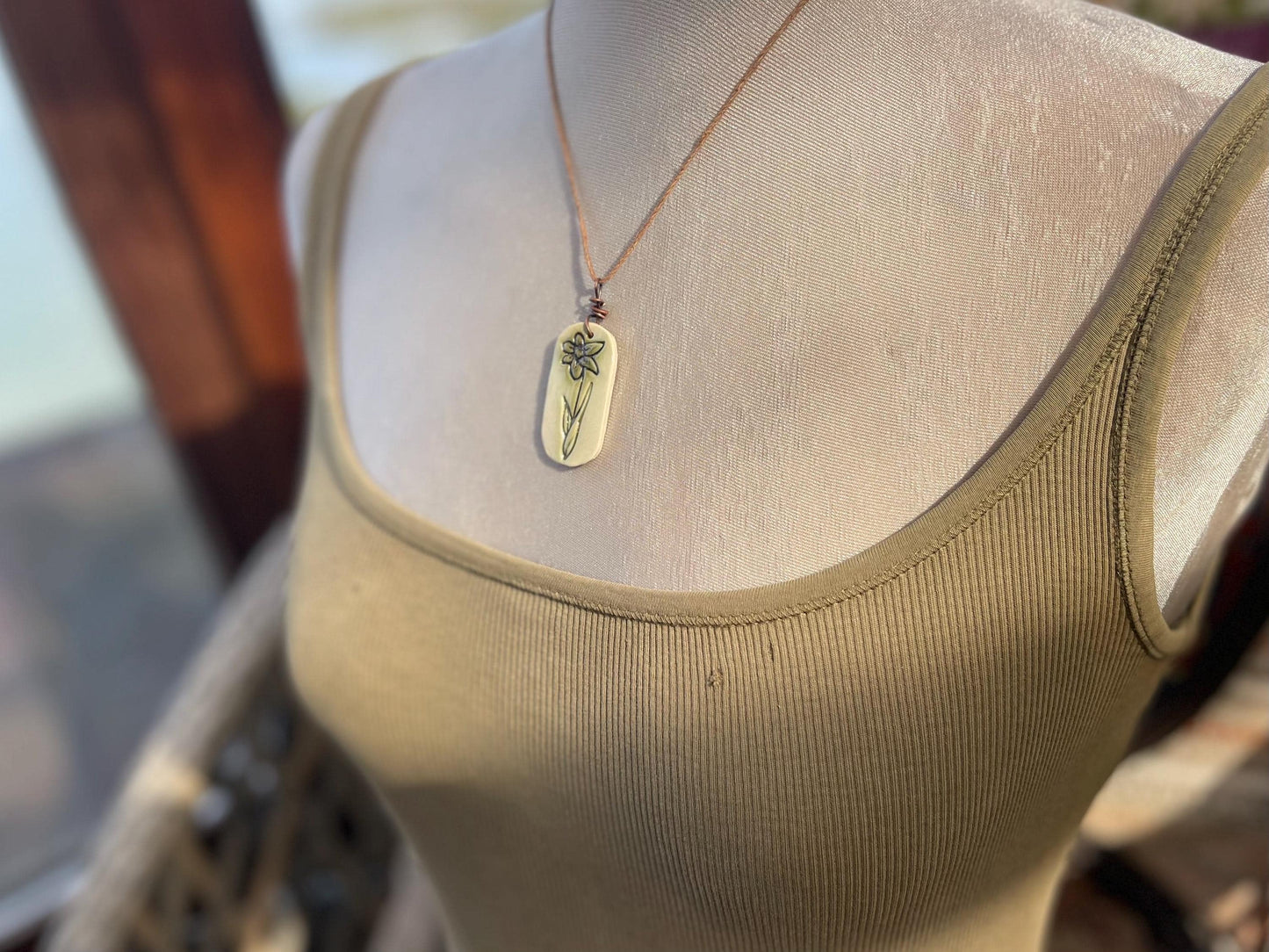 Handmade daffodil necklace. Eco friendly jewellery. Ethical pendants made with waste clay and burnt recycled copper. Ethical jewellery.