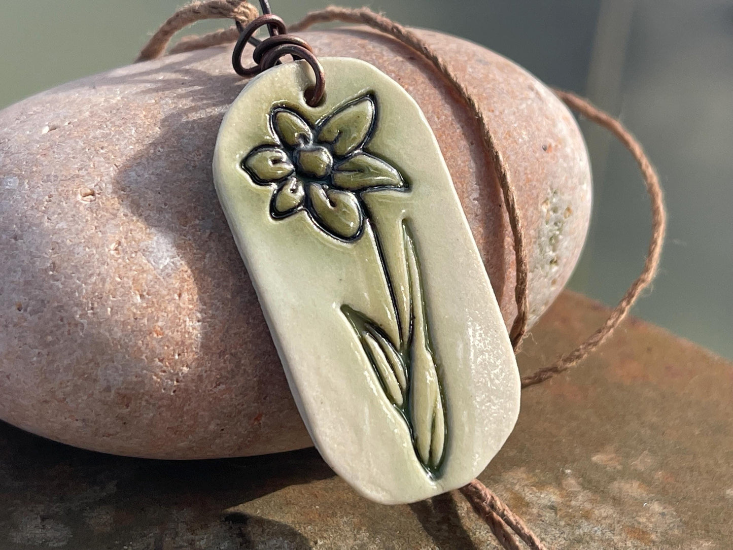 Handmade daffodil necklace. Eco friendly jewellery. Ethical pendants made with waste clay and burnt recycled copper. Ethical jewellery.