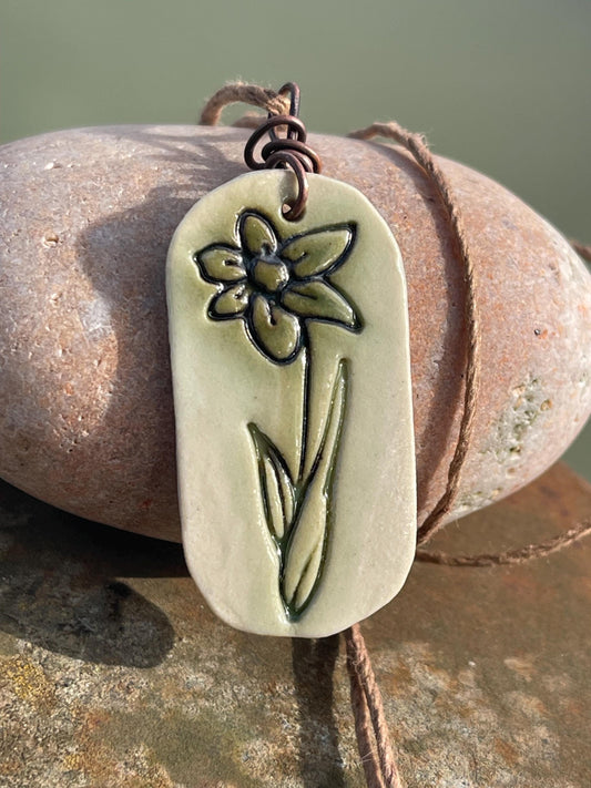 Handmade daffodil necklace. Eco friendly jewellery. Ethical pendants made with waste clay and burnt recycled copper. Ethical jewellery.