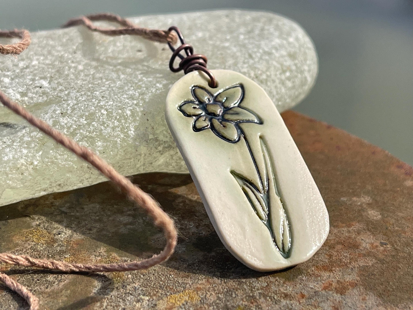 Handmade daffodil necklace. Eco friendly jewellery. Ethical pendants made with waste clay and burnt recycled copper. Ethical jewellery.
