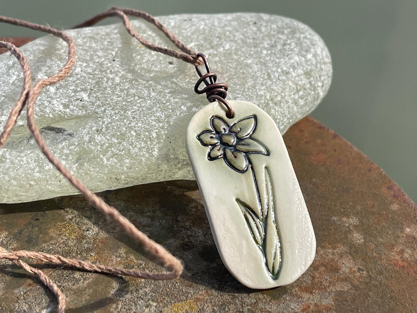 Handmade daffodil necklace. Eco friendly jewellery. Ethical pendants made with waste clay and burnt recycled copper. Ethical jewellery.