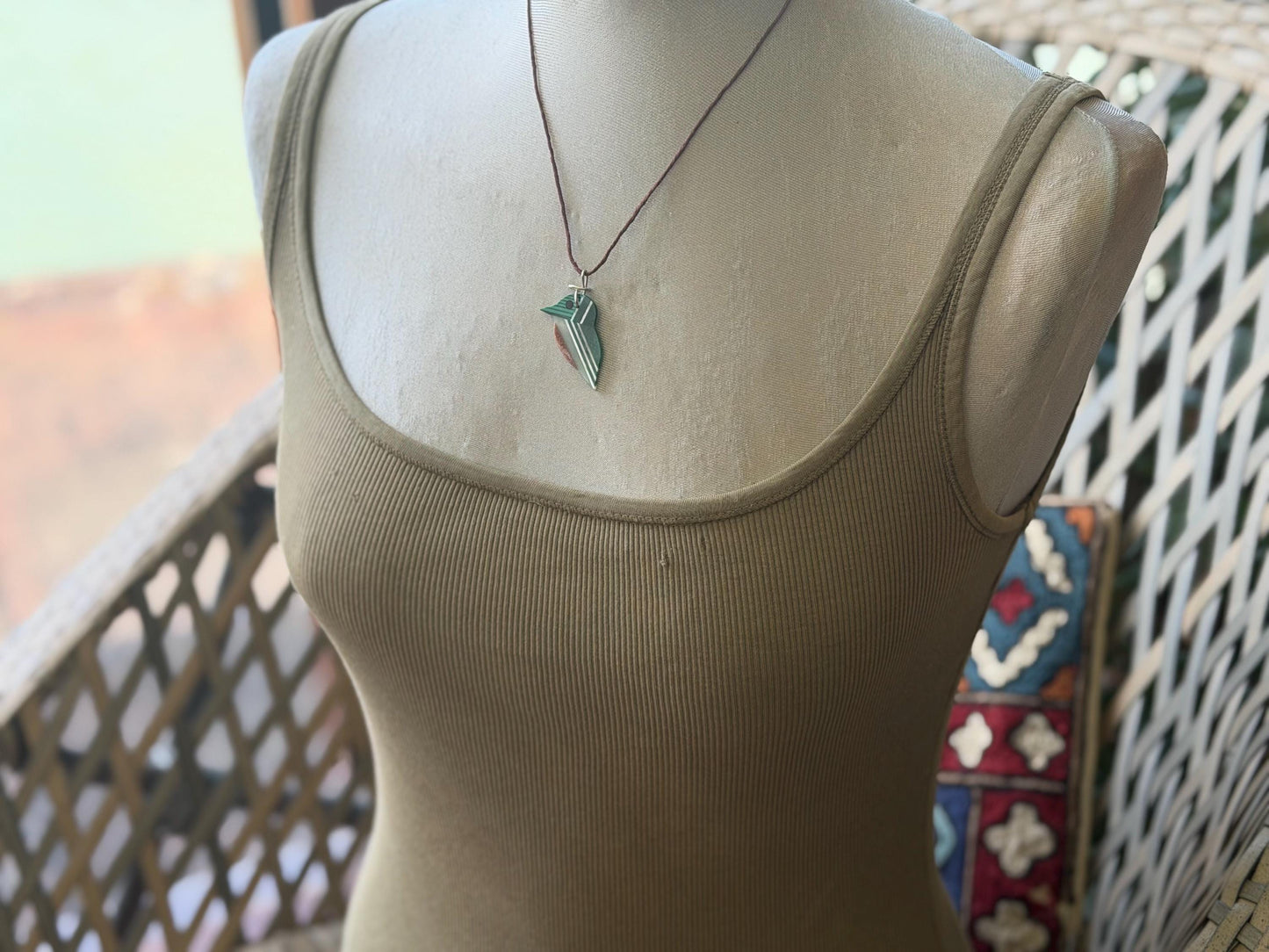 Kingfisher necklace showcasing strips of malachite. Green kingfisher pendant wrapped in recycled sterling silver.