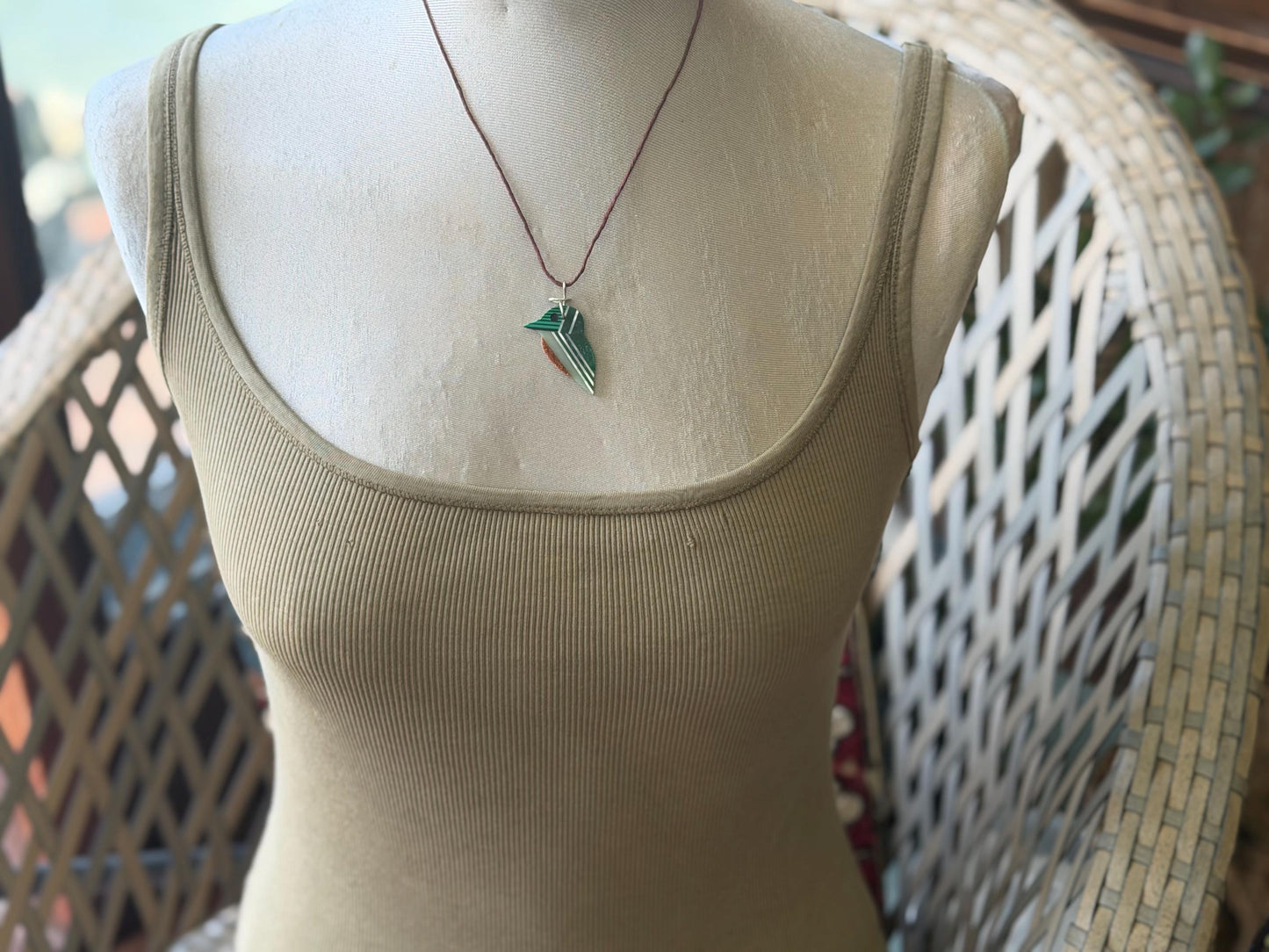 Kingfisher necklace showcasing strips of malachite. Green kingfisher pendant wrapped in recycled sterling silver.