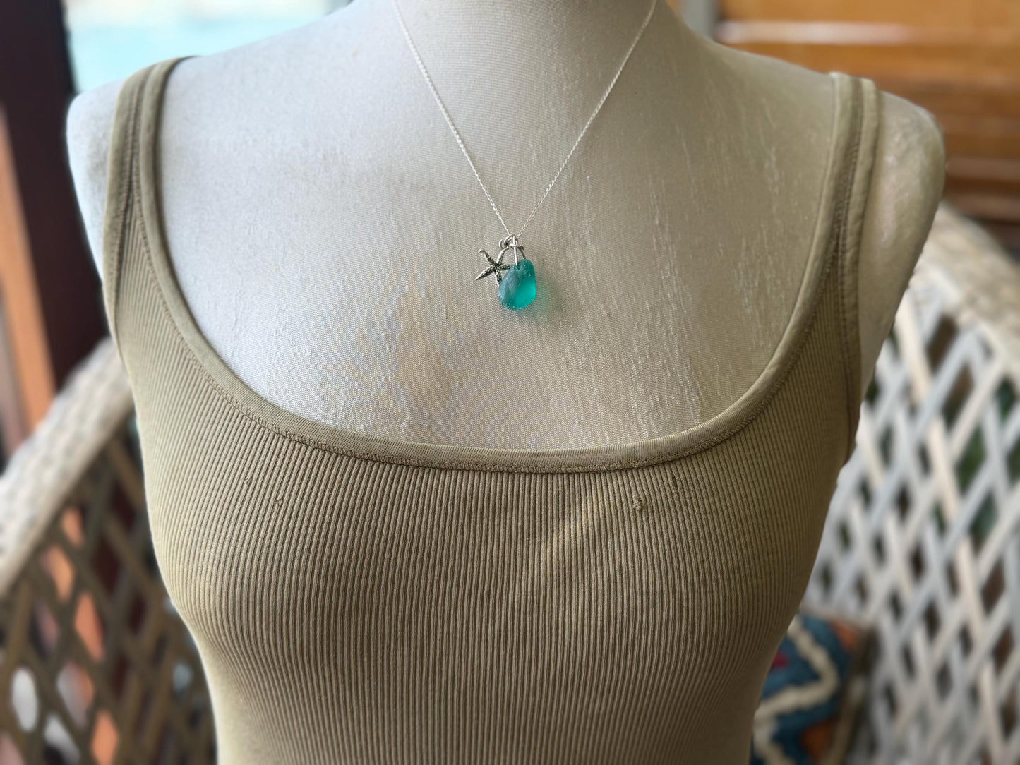 Eco friendly turquoise sea glass necklace on a sterling silver chain showcasing a little starfish. Starfish pendant, eco friendly jewellery.