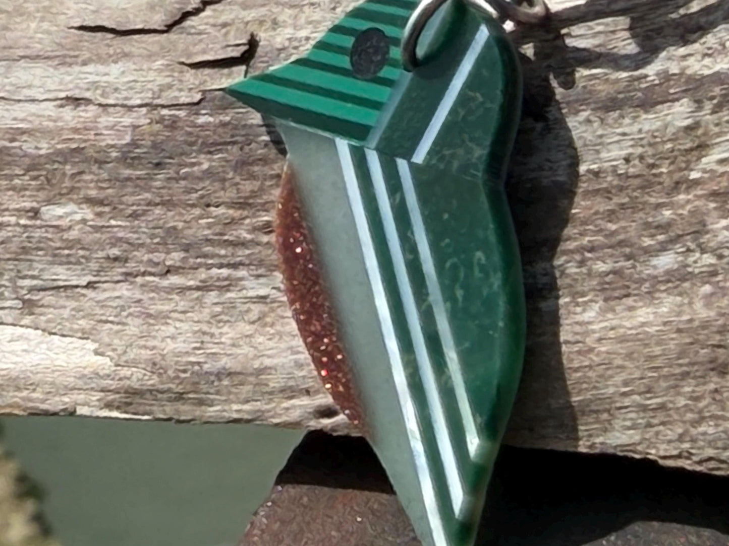 Kingfisher necklace showcasing strips of malachite. Green kingfisher pendant wrapped in recycled sterling silver.