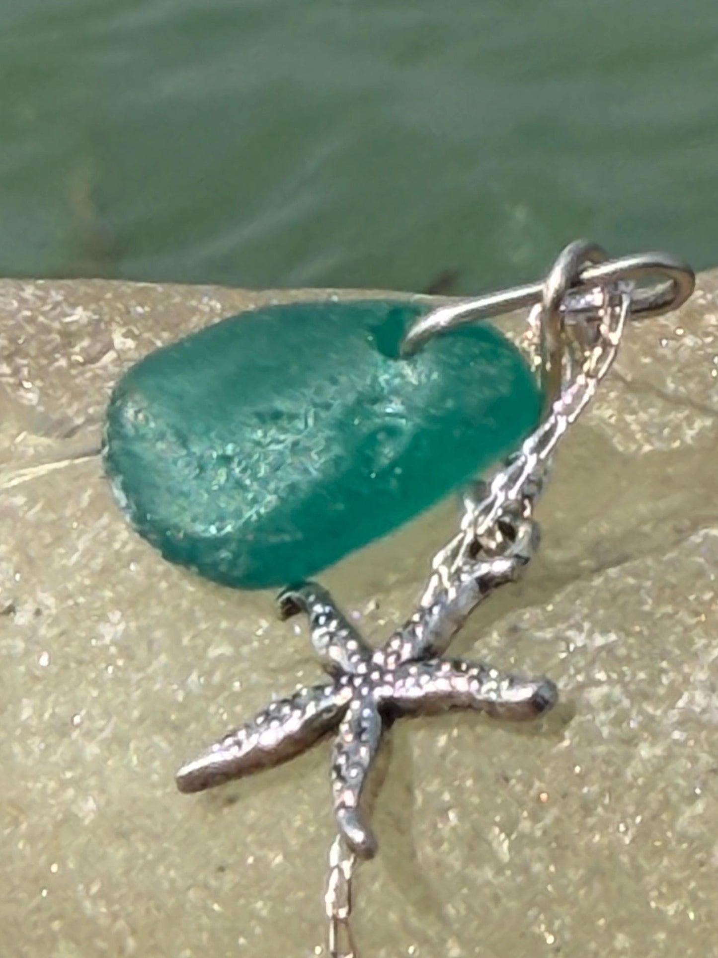 Eco friendly turquoise sea glass necklace on a sterling silver chain showcasing a little starfish. Starfish pendant, eco friendly jewellery.