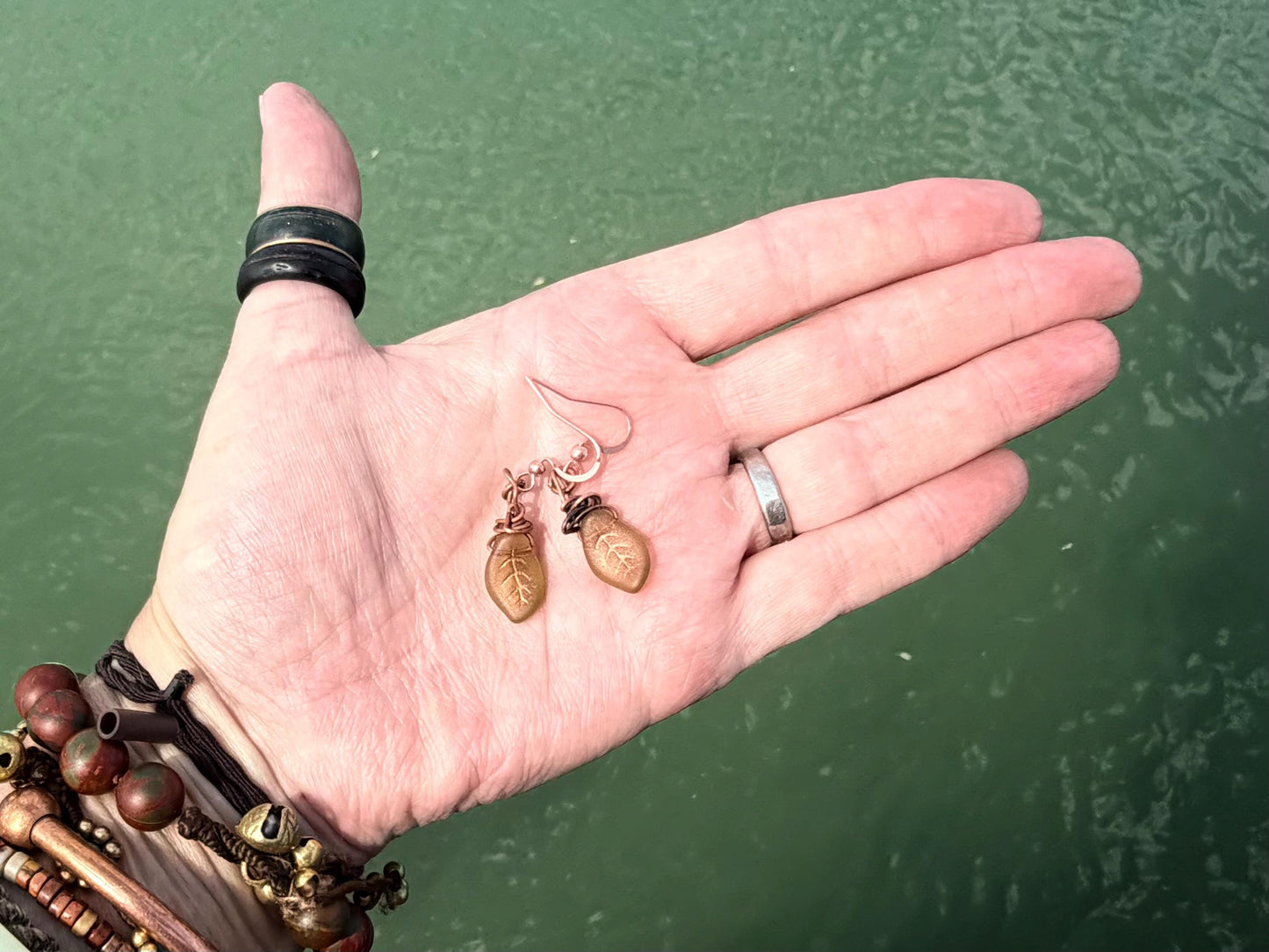 Upcycled glass leaves wrapped in recycled copper. Held on rose gold ear hooks. Eco friendly jewellery. Unique earrings. Leaf earrings.