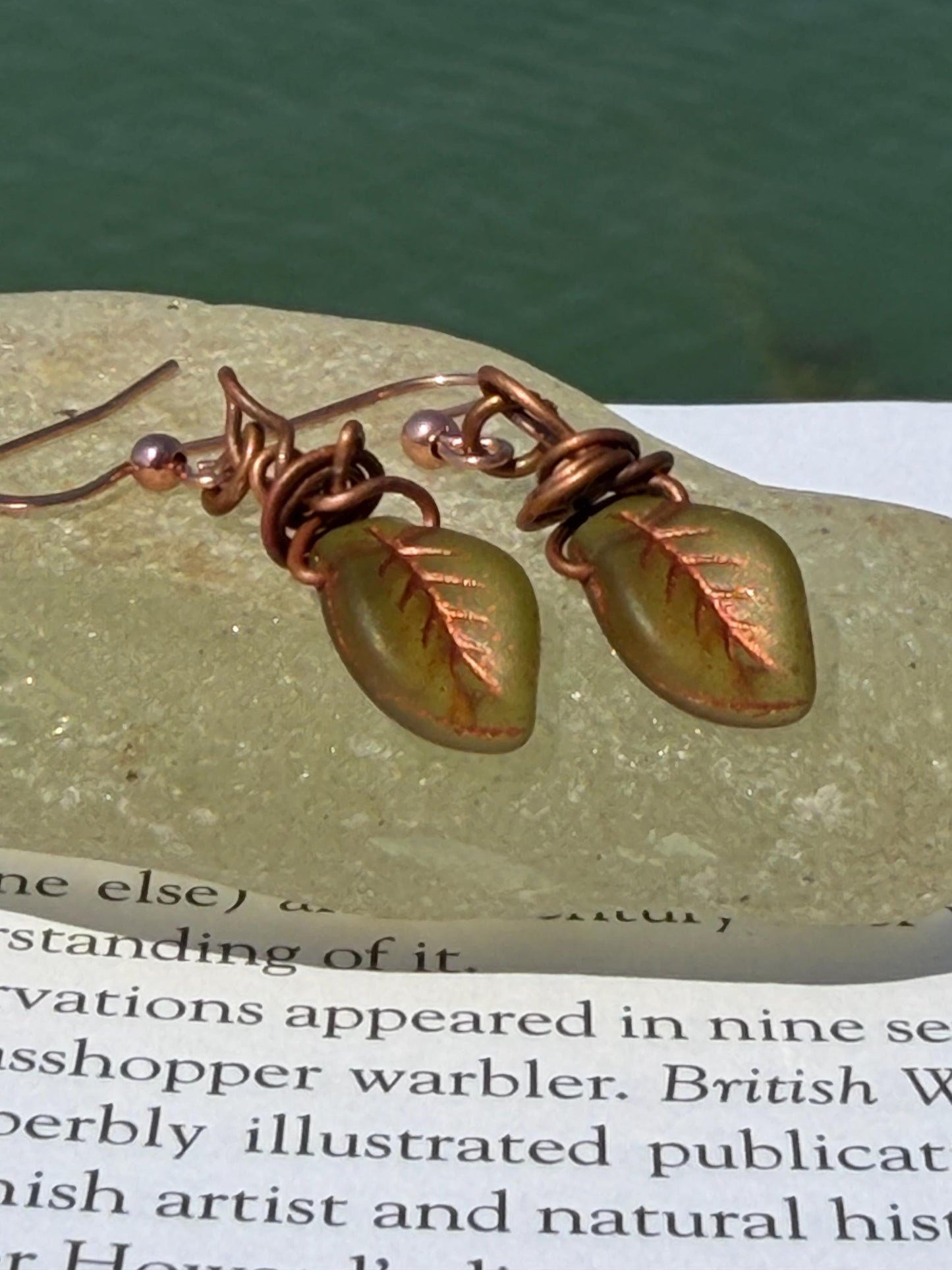 Upcycled glass leaves wrapped in recycled copper. Held on rose gold ear hooks. Eco friendly jewellery. Unique earrings. Leaf earrings.