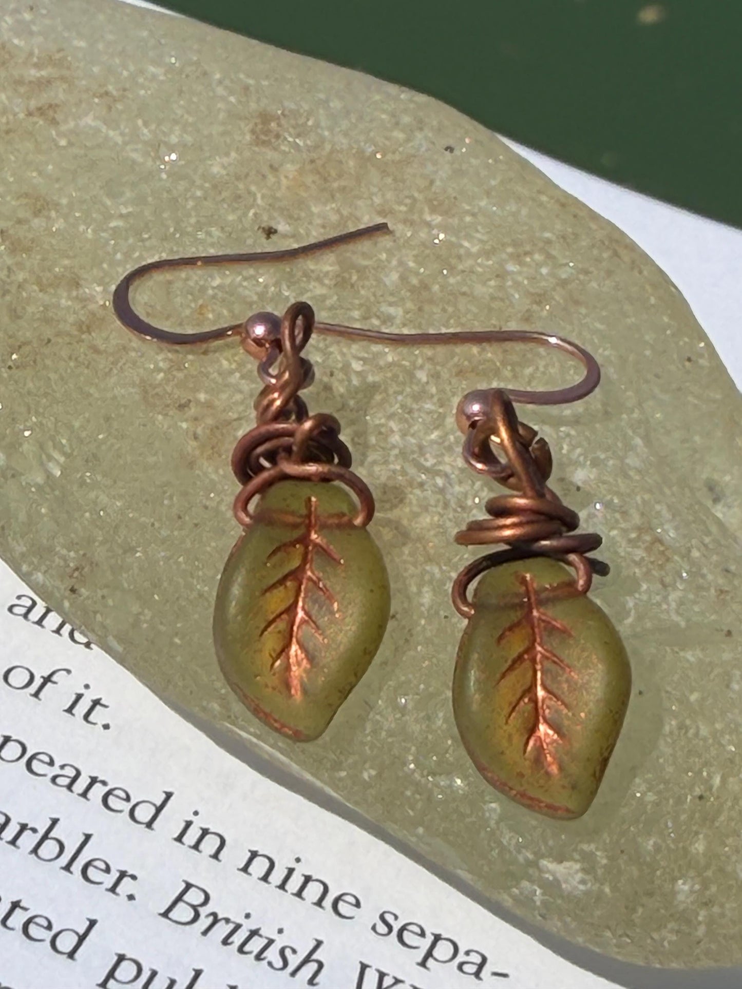 Upcycled glass leaves wrapped in recycled copper. Held on rose gold ear hooks. Eco friendly jewellery. Unique earrings. Leaf earrings.