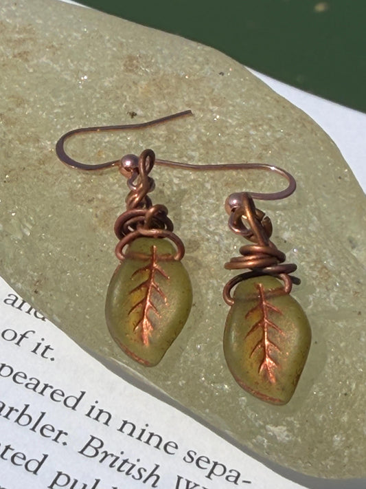 Upcycled glass leaves wrapped in recycled copper. Held on rose gold ear hooks. Eco friendly jewellery. Unique earrings. Leaf earrings.
