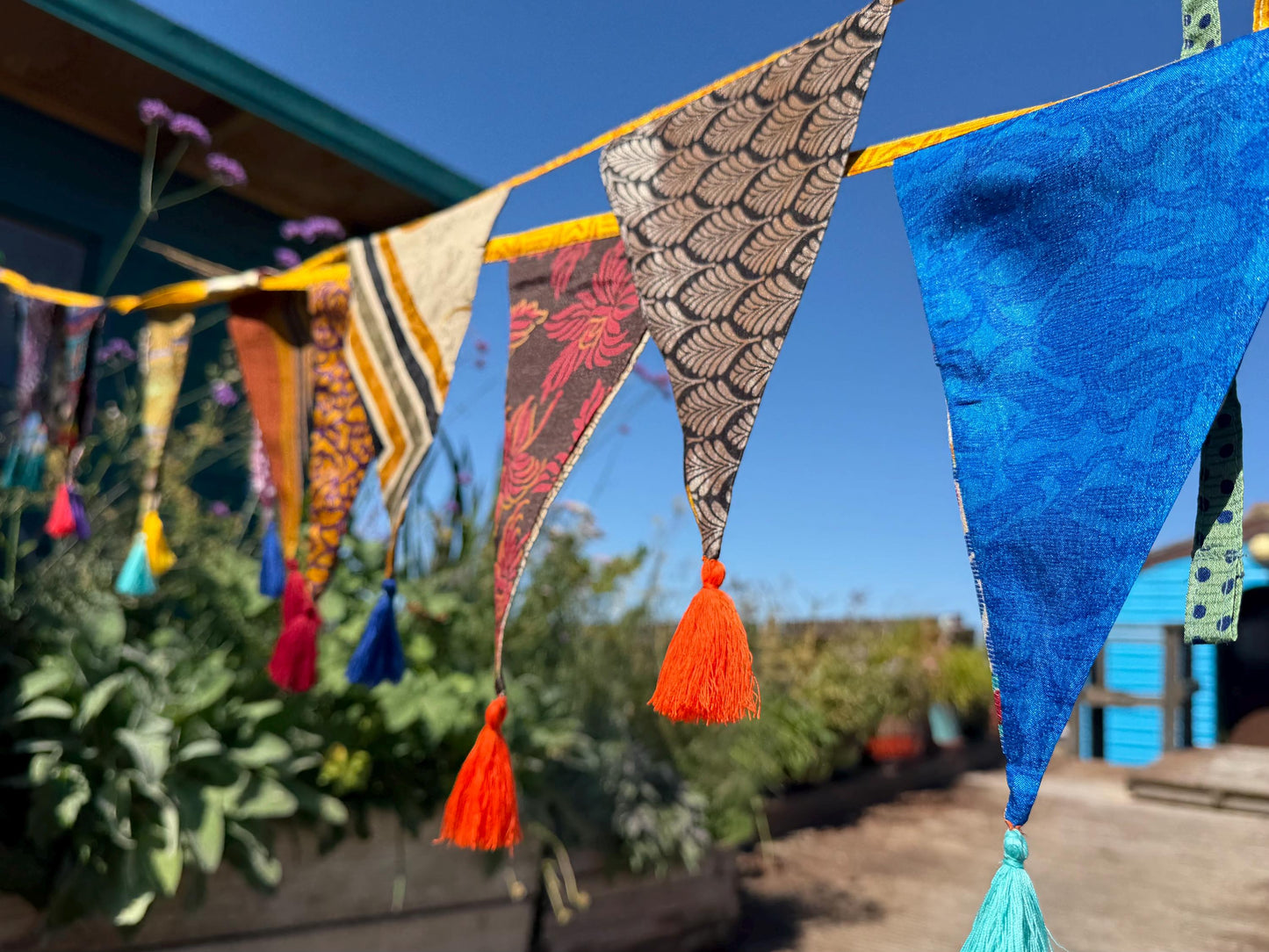 Recycled bunting with long ties and tassels. Boho bunting for home, garden and parties. Party flags with tassels.  Colourful  & eco friendly