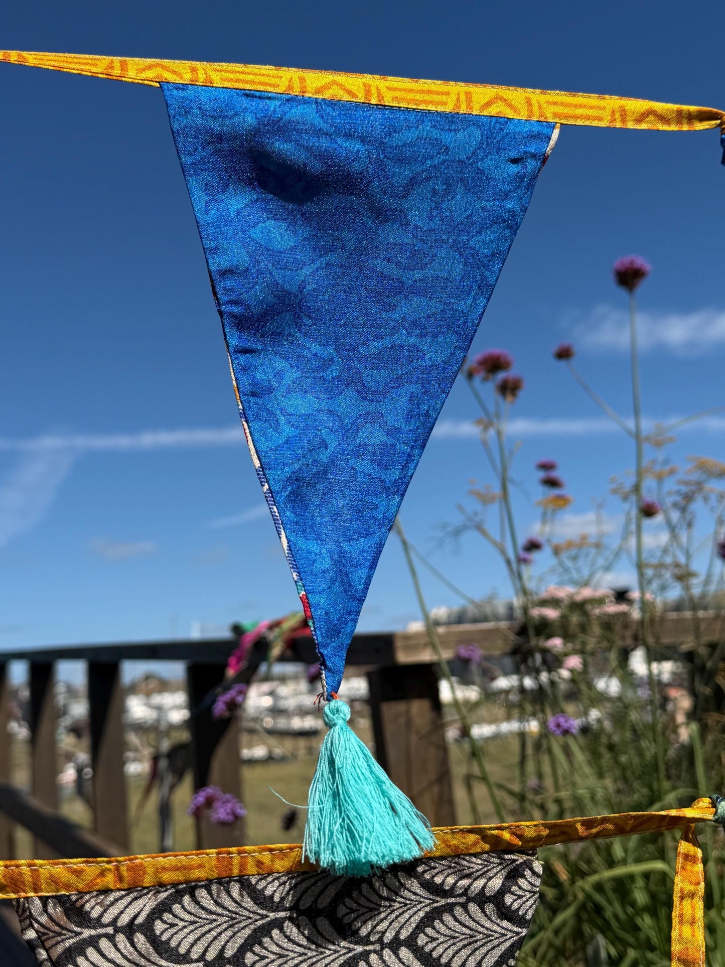 Recycled bunting with long ties and tassels. Boho bunting for home, garden and parties. Party flags with tassels.  Colourful  & eco friendly