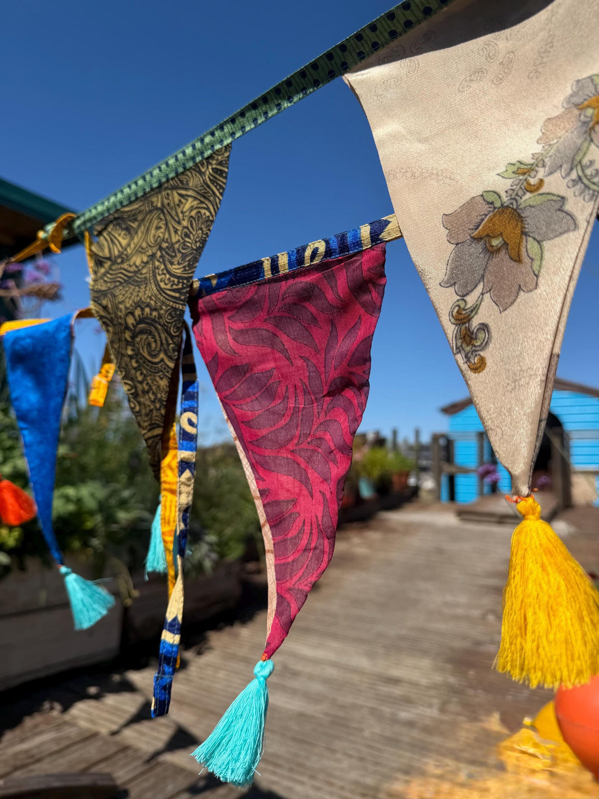 Recycled bunting with long ties and tassels. Boho bunting for home, garden and parties. Party flags with tassels.  Colourful  & eco friendly