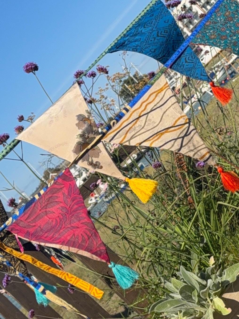 Recycled bunting with long ties and tassels. Boho bunting for home, garden and parties. Party flags with tassels.  Colourful  & eco friendly