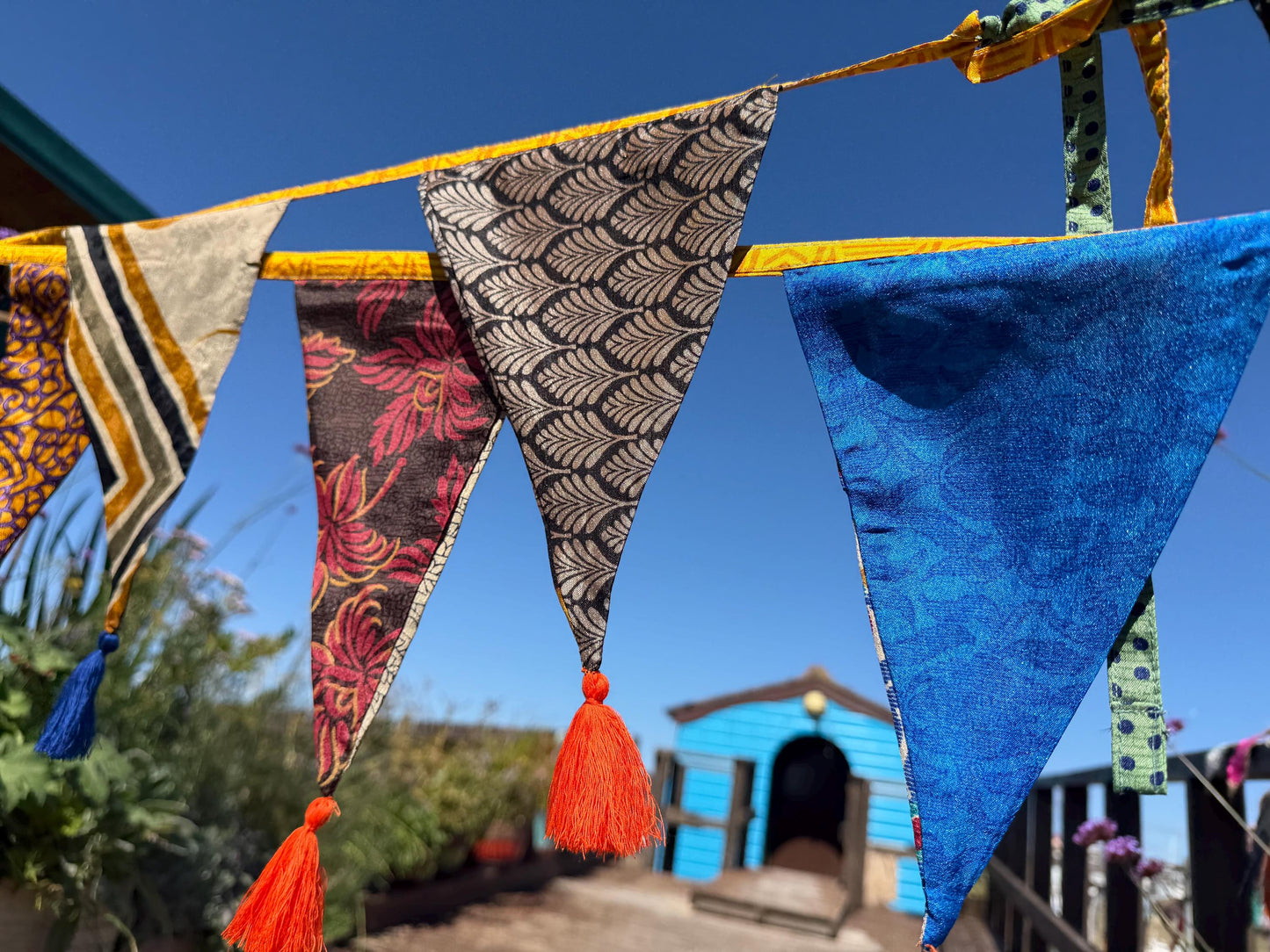 Recycled bunting with long ties and tassels. Boho bunting for home, garden and parties. Party flags with tassels.  Colourful  & eco friendly