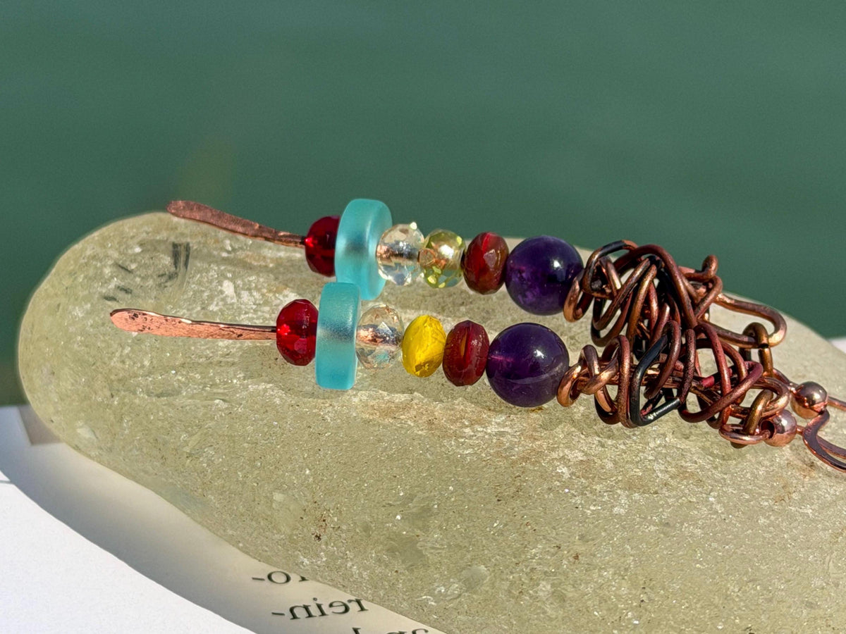 Eco friendly earrings made using recycled copper, sea glass & ethically sourced amethyst. Handmade ethical and unique jewellery.  Unusual.